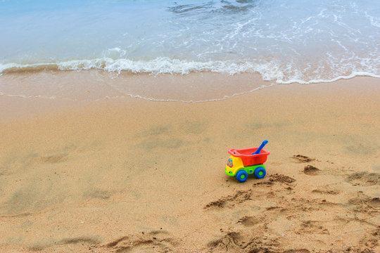 colorful toys for child sandboxes against the beach sand background/summer holidays background