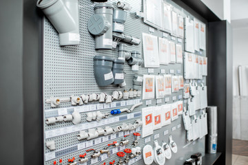 Showcase with water pipes and pipe joints in the plumbing shop
