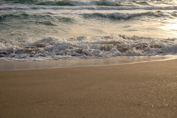Scenic view of the waves of the blue sea on the sandy shore.
Wild nature. Storm. Sunset on the sea.