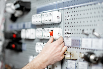 Choosing elecrical sockets in the shop with electrical goods, close-up view