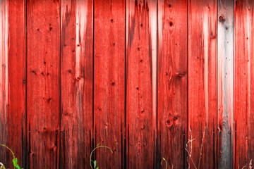 Wooden wall with a protective layer of red paint.