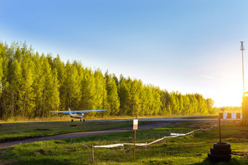 Light passenger planes parked before departure at private airport in Kronshtadt, St.Petersburg, Russia. Industrial and civil air transportation by aircraft. Professional flights on airplanes - obrazy, fototapety, plakaty