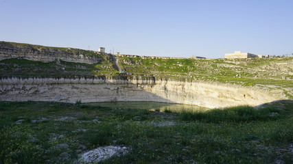 Fototapeta na wymiar Obruk sinkhole landscape around Konya Province, Turkey. Panoramic view of karst lake in Asia. Reflection of a crater lake. a cavity ground, especially in limestone bedrock, caused by water erosion.