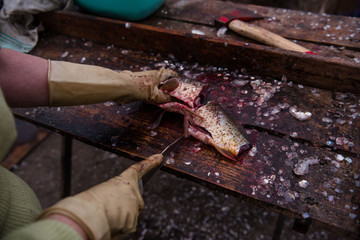 Cutting and cleaning fish with a knife on the cutting table