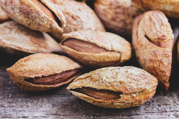 A pile of almonds on white background. Almonds are rich in nutrients, vitamins, and minerals that are essential to the body.