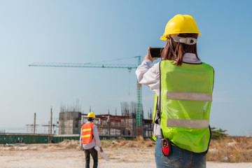 Engineers using mobile phone at construction site