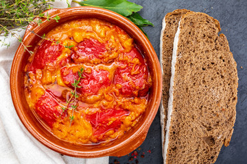 Peppers (del Piquillo) stuffed with meat or fish. Roasted red peppers and fillings made at home. Recipe of Spanish food and Mediterranean diet. With delicious sauce to spread bread.