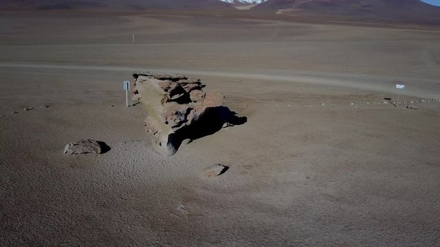 Aerial view Arbol de Piedra stone with the form of a tree at Siloli Desert at Salar de Uyuni, Bolivia, South America, an awe rocky formation inside Andes mountains and valleys and amazing road trip