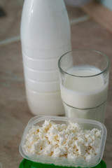 several milk products in glass, lunch box and bottle on table. healthy eating and proteine diet