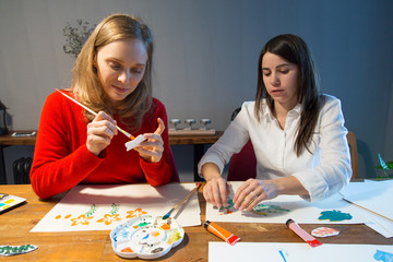 Fototapeta premium Two peaceful girls enjoying simple painting