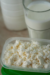 several milk products in glass, lunch box and bottle on table. healthy eating and proteine diet