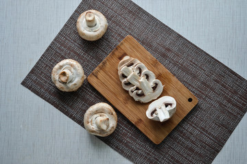 sliced champignon mushrooms on a cutting board