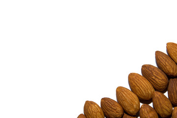Close-up of almonds. Almonds in the corner. From the side. On white background. Isolated.