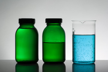 Liquid in laboratory bottles. Scientific biochemical laboratory. Colorful liquid.