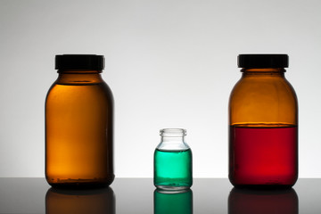 Liquid in laboratory bottles. Scientific biochemical laboratory. Colorful liquid.