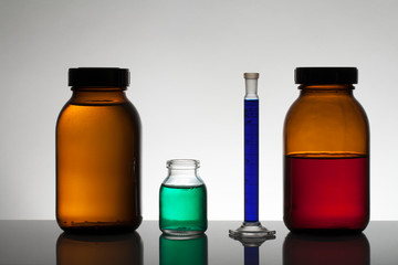 Liquid in laboratory bottles. Scientific biochemical laboratory. Colorful liquid.
