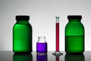 Liquid in laboratory bottles. Scientific biochemical laboratory. Colorful liquid.