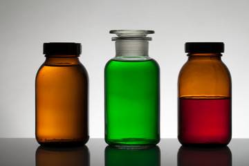 Liquid in laboratory bottles. Scientific biochemical laboratory. Colorful liquid.