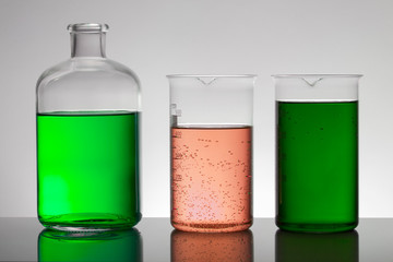 Liquid in laboratory bottles. Scientific biochemical laboratory. Colorful liquid.