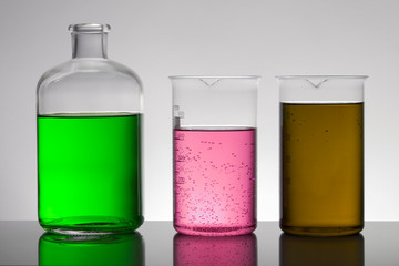 Liquid in laboratory bottles. Scientific biochemical laboratory. Colorful liquid.