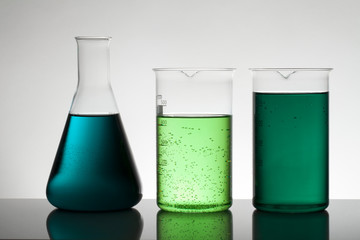 Liquid in laboratory bottles. Scientific biochemical laboratory. Colorful liquid.