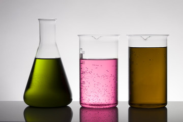 Liquid in laboratory bottles. Scientific biochemical laboratory. Colorful liquid.
