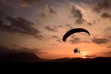 paraglider silhouette at sunset