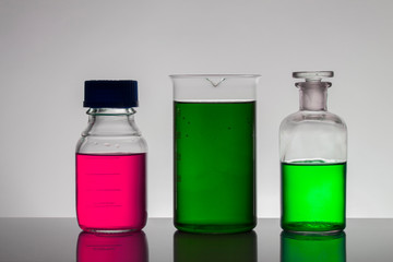 Liquid in laboratory bottles. Scientific biochemical laboratory. Colorful liquid.