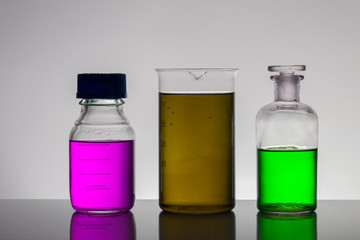 Liquid in laboratory bottles. Scientific biochemical laboratory. Colorful liquid.