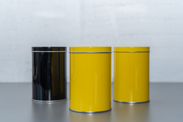 Colored metal cans on a gray table