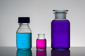 Liquid in laboratory bottles. Scientific biochemical laboratory. Colorful liquid.