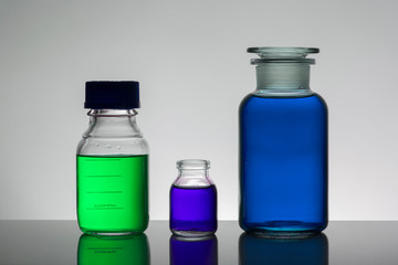Liquid in laboratory bottles. Scientific biochemical laboratory. Colorful liquid.