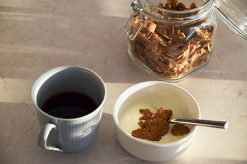 Coffee, cornflakes and yoghurt for breakfast