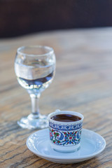 a сup of black coffee and a glass of clean water