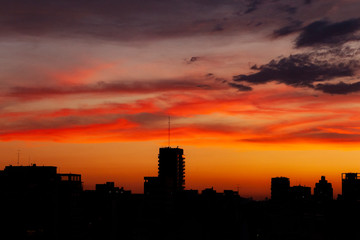 Fototapeta na wymiar Silhouettes Sunset in the City. Orange Sky. City Background.