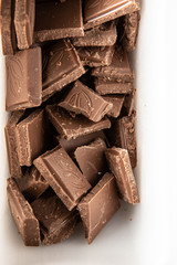 Top view on pieces of dark chocolate in a white tray