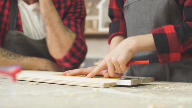 profession, carpentry, woodwork and family concept - carpentery masterclass for little children and their fathers to share basic knowledge of working with wood.
