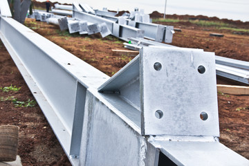 Galvanized parts. Galvanized parts on a construction site in rainy weather. Waiting for the installation of metal structures.