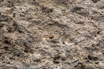 Textured uneven stone surface. Yellow limestone. Background image. Construction material.