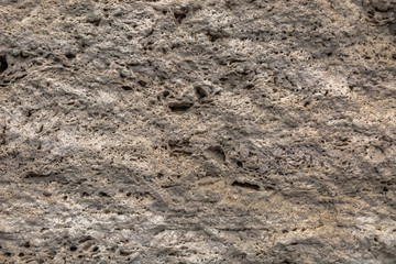 Textured uneven stone surface. Yellow limestone. Background image. Construction material.