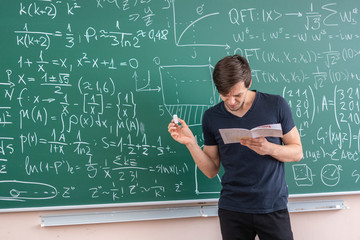 pupil doing homework on blackboard b