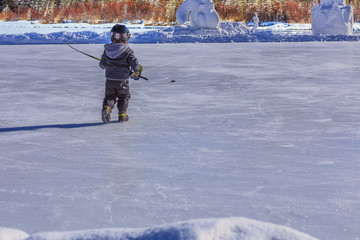 Young Hockey Player Chasing a Puck