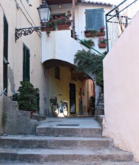 Italy, Tuscany: Alley with bicycle in Porto Azzurro.