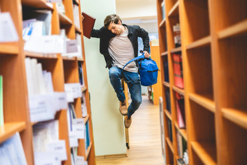 happy student jumping with books and backpack b