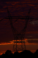 high voltage poles and sunset