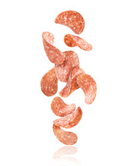 Sliced sausage falls down, isolated on white background