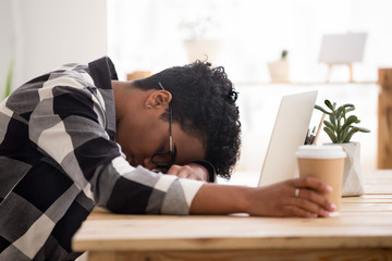 Bored exhausted african american woman falling asleep sleeping at workplace