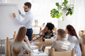 Businessman coach give business presentation on flipchart at group meeting