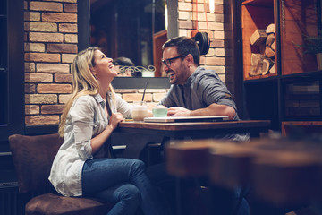 Beautiful couple on a romantic date in cafe - Image - obrazy, fototapety, plakaty