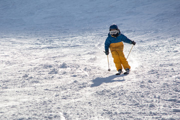 Fototapeta na wymiar Child on ski track in winter time 